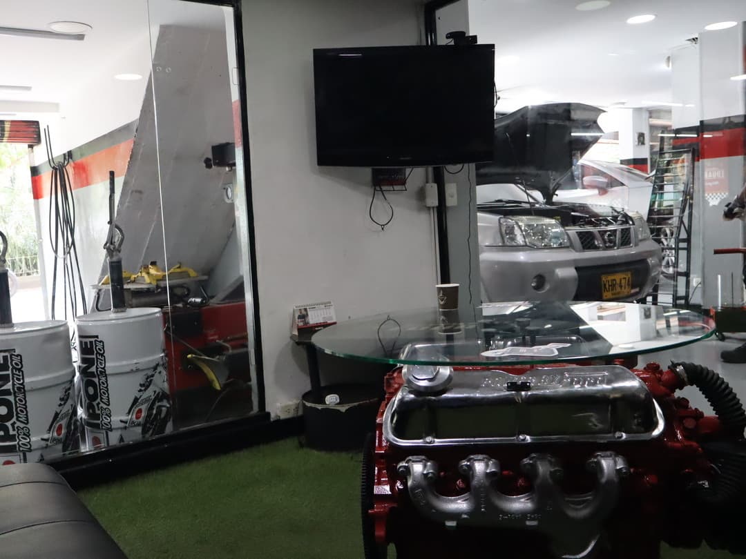 Área de entretenimiento con TV en taller mecánico Medellín